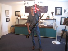 Me holding a musket rifle in the Lloyd Tilghman House & Civil War Museum.